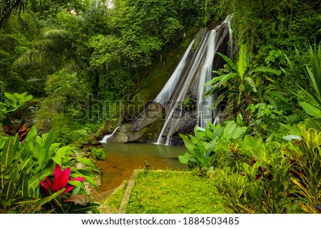 View to waterfall in rainforest. Tropical landscape. Adventure and travel concept. Nature background. Slow shutter speed, motion photography. Water flow. Antapan waterfall Bali, Indonesia
