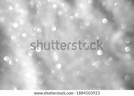 Trendy abstract silver gray circles bokeh festive glitter background. Christmas lights bokeh overlay pattern. Modern color design.