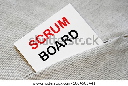 SCRUM BOARD text on the white sticker in the shirt pocket.