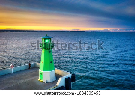 The lighthouse at the exit to the Baltic Sea in New Port at sunset, Gdansk. Poland Royalty-Free Stock Photo #1884505453