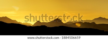Golden sunrise over mountain peaks