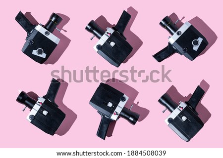 80s film camera on pink background with a shadow