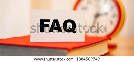 FAQ on white paper with clock background. Knowledge on remote online education.