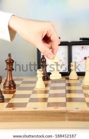 Woman playing chess, close up