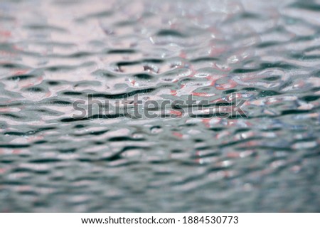 Creative background. Crust of ice on car glass close up