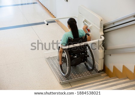 Disability stairs lift facility indoor building Wheelchair elevator. Royalty-Free Stock Photo #1884538021