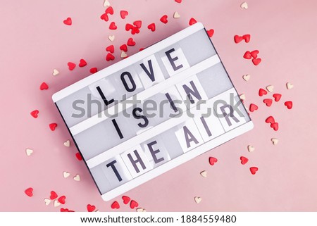 Text Love Is In The Air written on lightbox