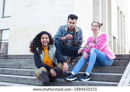 cute group of teenages at the building of university with books huggings, diversity nations real students lifestyle
