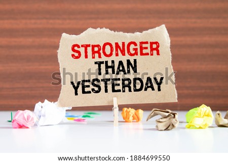stronger than yesterday white chalk text on a vintage slate blackboard
