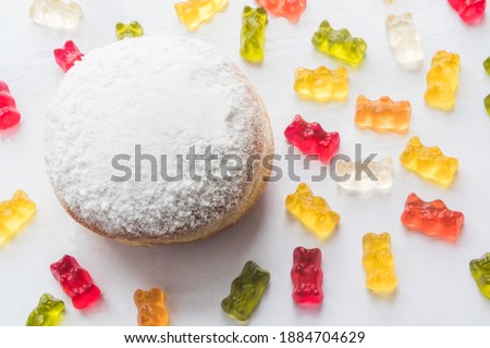 Berlin donut with colorful gummy bears, Top view- typical food at the German carnival - krapfen
Sweets and desserts concept.