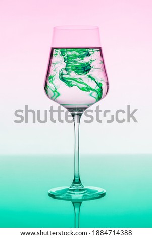 a wine glass in which blue ink dissolves