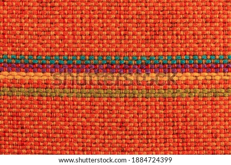 Texture and interlacing of orange striped fabric. Textile. Empty background.