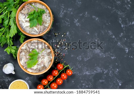 Aspic and fresh vegetables. Headcheese.The national dish of Russian, Ukraine and Belarus. .Jelly. Tomatoes and parsley.Jellied minced meat. Flat lay. Copy space. Place for text.