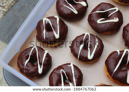 a sweet dessert donuts with colorful chocolate and toppings, delicious homemade donuts for snack at home