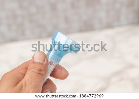 Bottle for PCR test with saliva Royalty-Free Stock Photo #1884772969