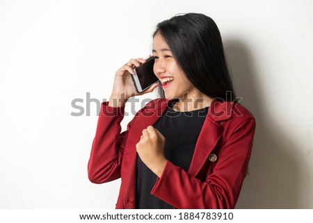 Young asian business woman speaking on the phone on white background