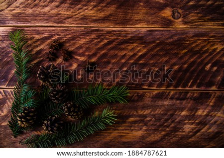 Christmas cones and branches on wooden boards