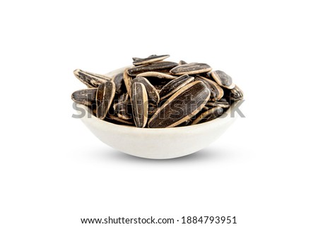 sunflower seeds in the bowl isolated on white background. Close-up