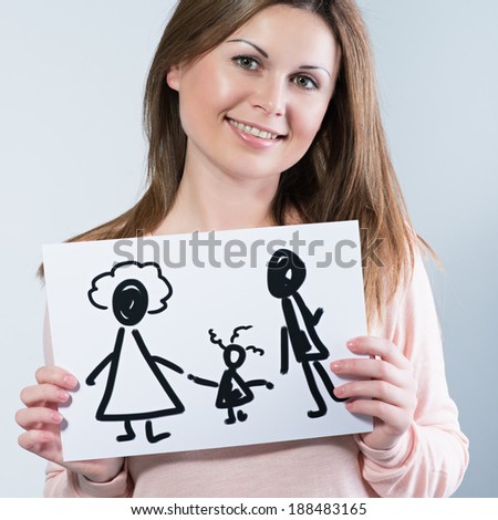young woman holding picture with happy family. Photo in color style instagram filters 