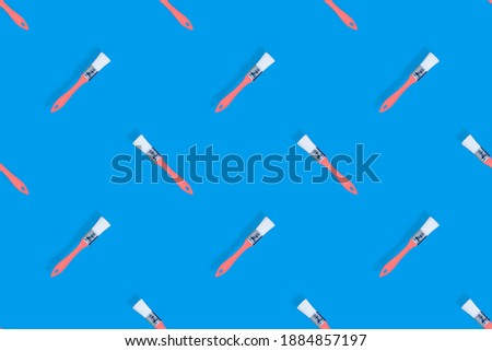 Construction brushes on a blue background. Seamless texture from construction brushes.