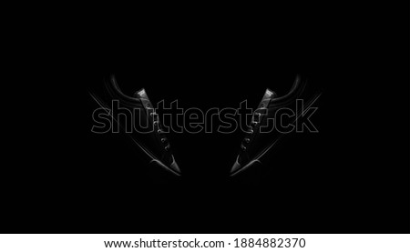 Black and white photo of vintage low top sneakers shoes isolated on black background.