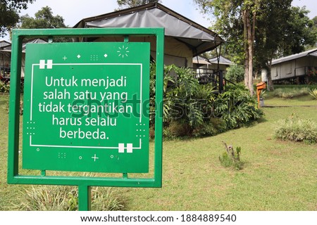 Quote board from glamping land in Bandung - Indonesia with translation "For being irreplaceable we have to different from others"