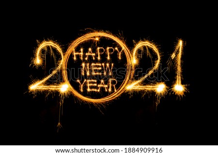 Happy new year 2021 written with sparkle fireworks on isolated black background