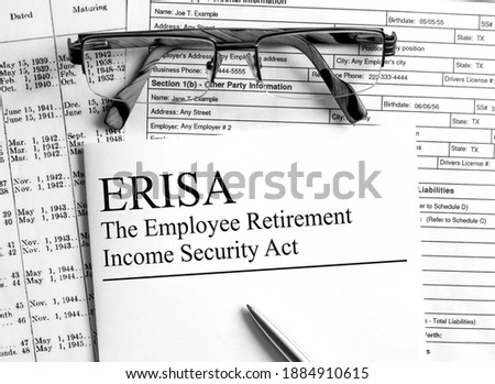 Paper with text ERISA on a financial table with eyeglasses and metal pen. Financial and concept photo