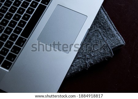 The black keyboard and turned off screen of a laptop.