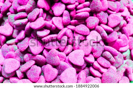 candy heart for Valentine's day. Candy A lot of sweets. Colorful texture using a background. Background rendering. Bright multiple jelly candies in powdered sugar. Confectionery wallpaper concept
