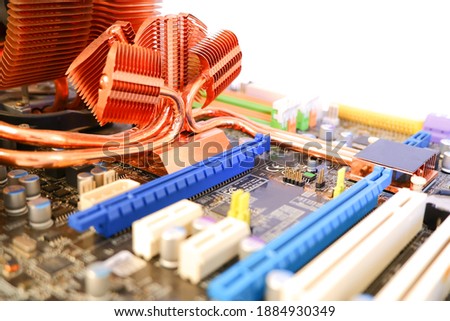 Copper heatsink on mainboard computer on white background