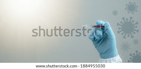 CORONAVIRUS - CORONA VACCINATION STOP COVID-19 - Doctor with syringe in hand injects Corona vaccine, isolated on gray blue background with cartoon virus symbol