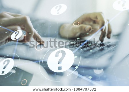 Creative abstract question mark hologram and hands typing on computer keyboard on background, future technology concept. Multi exposure Royalty-Free Stock Photo #1884987592