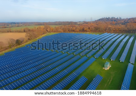 Aerial view of a solar farm near Southampton in Hampshire, England, Europe. Solar energy is radiant light and heat from the sun. Solar farm designed for the supply of power into the electricity grid. Royalty-Free Stock Photo #1884994618