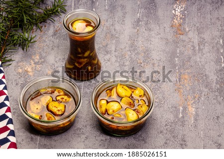 Glass jars with garlic cloves pickles with copy space. Healthy food preservation. Natural medicine.