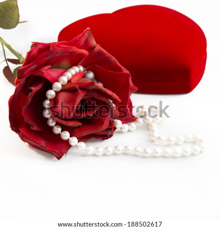 Beautiful red rose with necklace of pearls