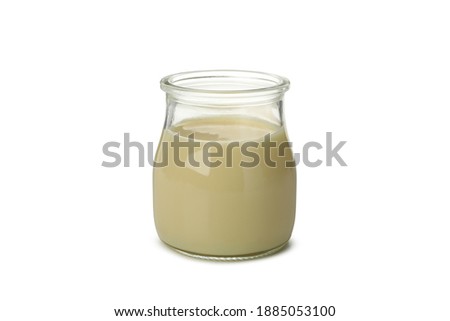 Glass jar with condensed milk isolated on white background Royalty-Free Stock Photo #1885053100