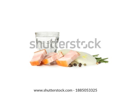Glass of vodka, bacon and spices isolated on white background