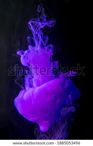 Smooth movement of purple ink in water on a dark background.