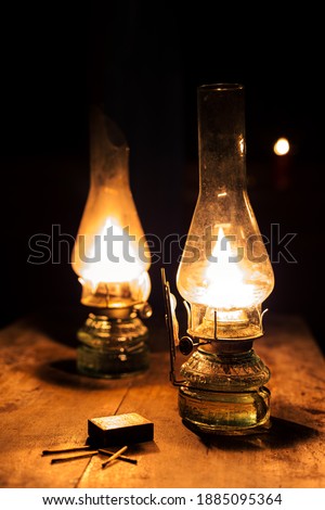 Two oil lamps in a dark house Royalty-Free Stock Photo #1885095364