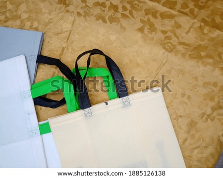 Colorful Loop Handle Non-woven Polypropylene Shopping Bags. ECO Friendly Concept. Single Use Fabric Bags. Copy space for text and logo for advertisements 