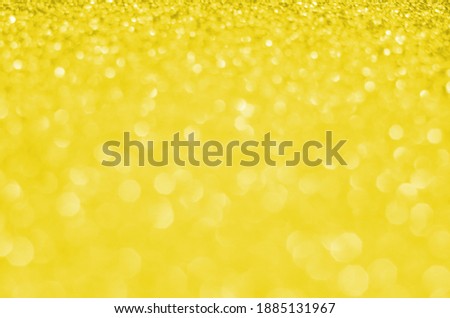 Illuminating Pantone Color Of The Year 2021. Abstract festive bokeh background with shining defocus sparkles. Blurred glitters shimmering dust macro close up, copy space for text logo.