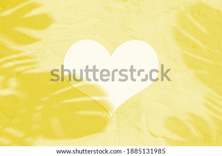 Heart valentine blank white paper sheet with tropic shadow overlay. Illuminating Pantone Color Of The Year 2021. Modern and stylish greeting card or wedding invitation mock up