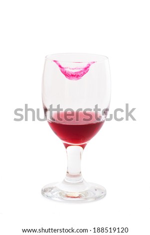 Red Wine in Glass on a White Background. Close up.