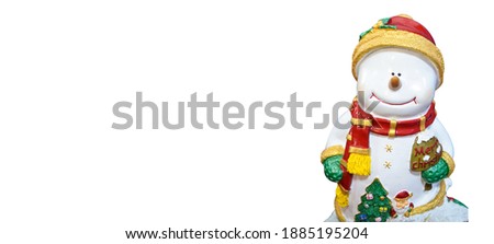 Smile snowman in snow wearing red hat and scarf.Smile snowman in snow wearing  green glove.snowman doll with"merry chrismas" word on white background with copy space and clipping path.