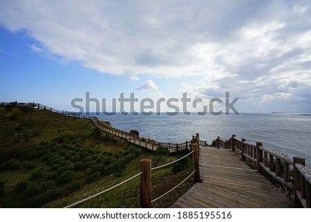 a beautiful seascape with walkway, against charming clouds
