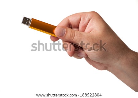 A golden usb flash memory hold by a hand, isolated on a white background
