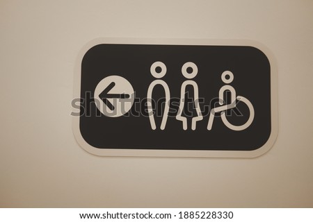 A restroom sign toilet male female and cripple public on wall
