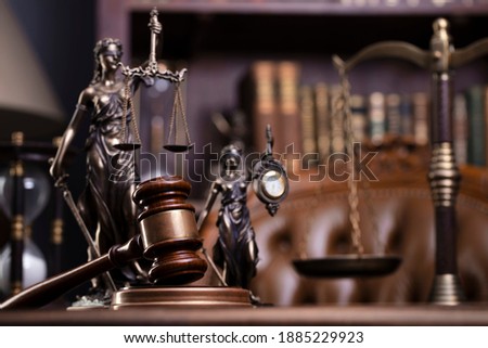 Juridical concept. Judges gavel, scales of justice, Themis, hourglass, books, lawyers desk.