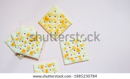 Classical salted taste cracker on light lavender background
